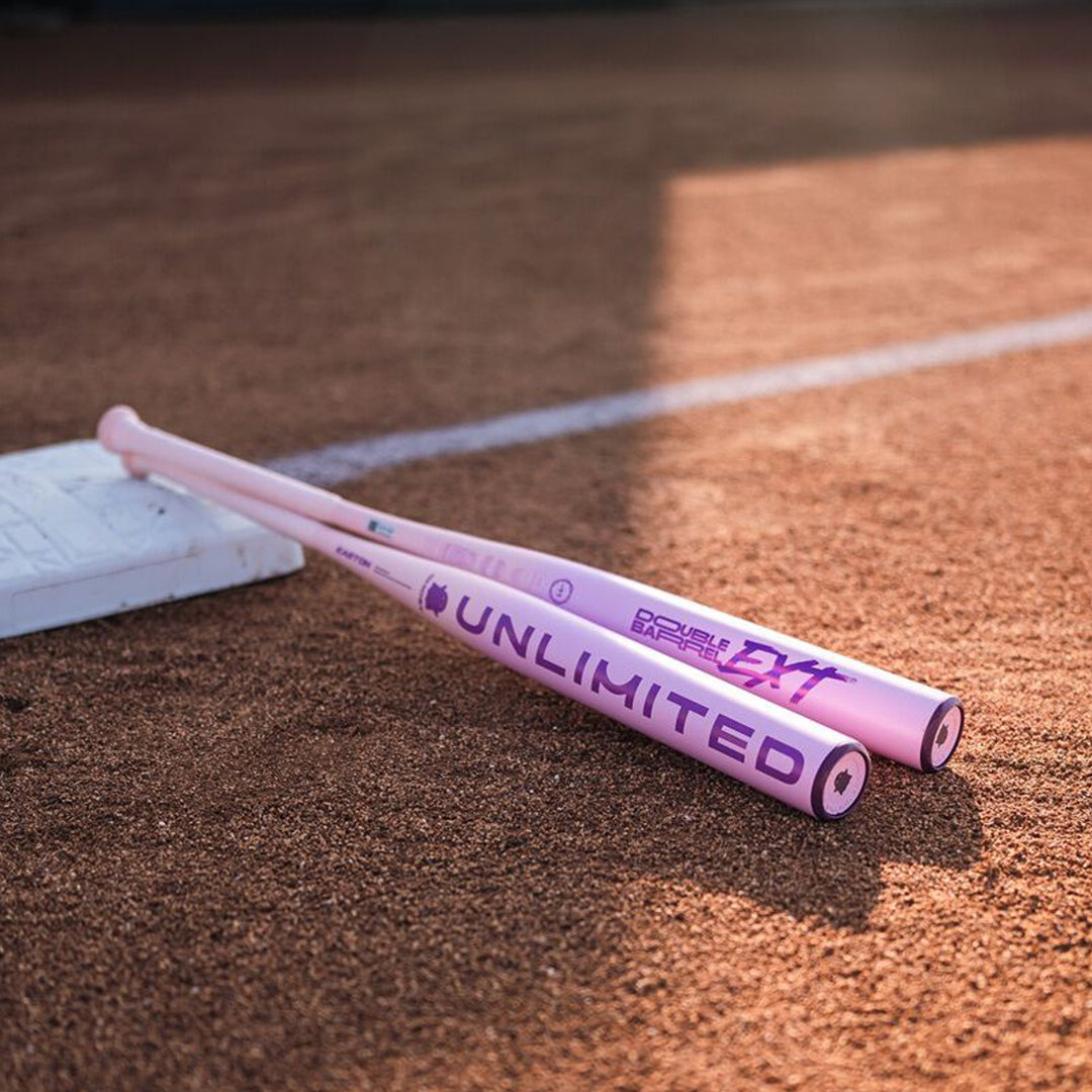 Easton Ghost Unlimited composite fastpitch bats displayed on softball field
