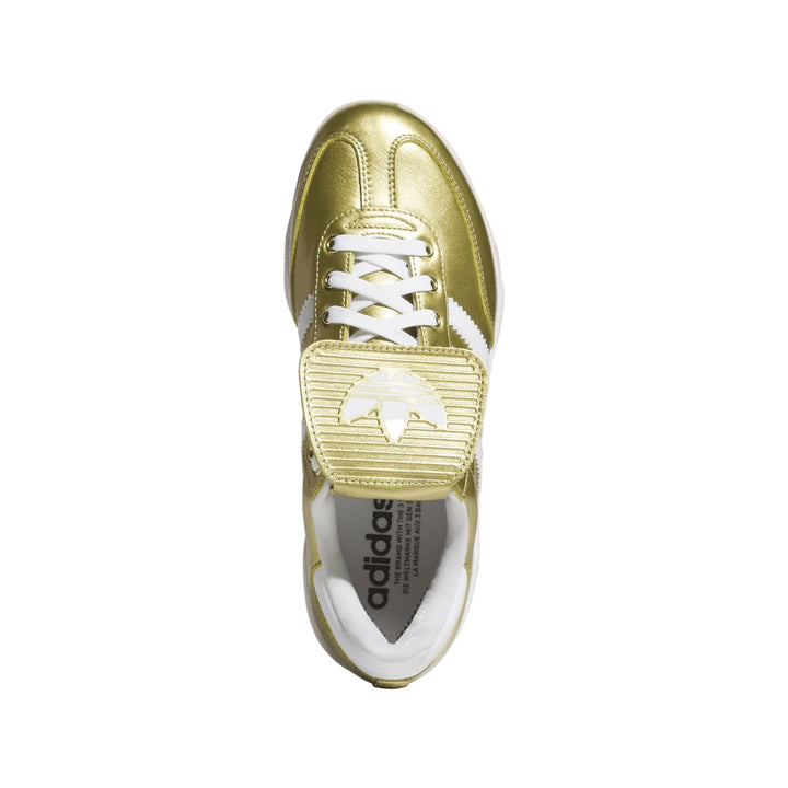 Top view of gold adidas Samba baseball cleat with fold-over tongue